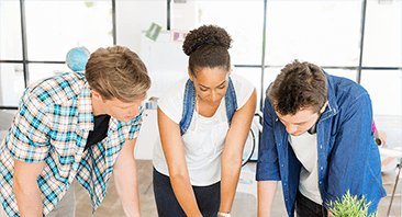 three persons consulting each other with discussion